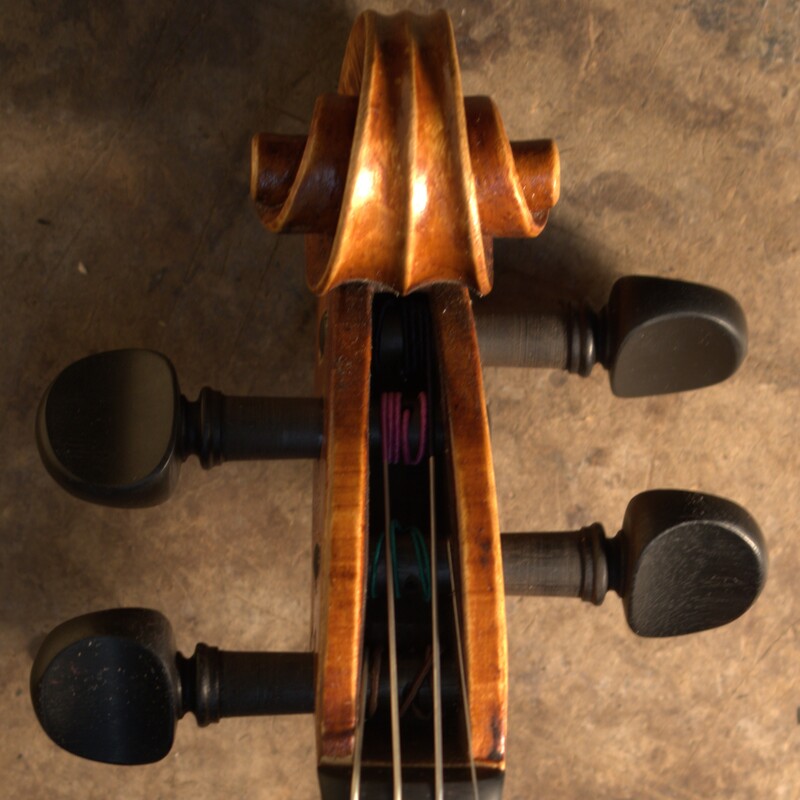 Front view of a Guarneri model violin scroll